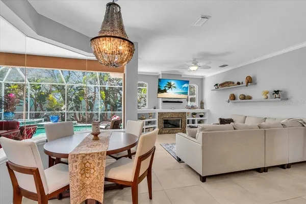 a dining room with furniture a chandelier and a rug
