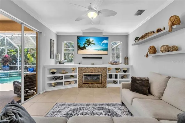 a living room with furniture a flat screen tv and a fireplace