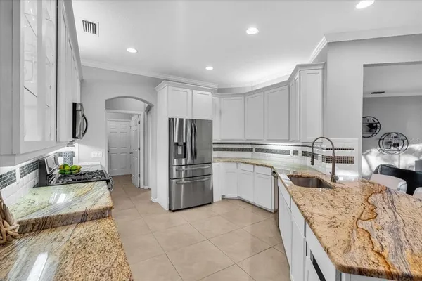 a kitchen with refrigerator and cabinets
