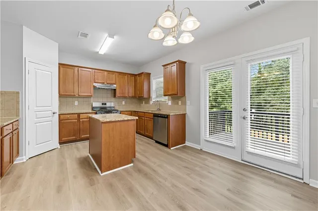 a kitchen with a refrigerator a stove cabinets and a counter top space