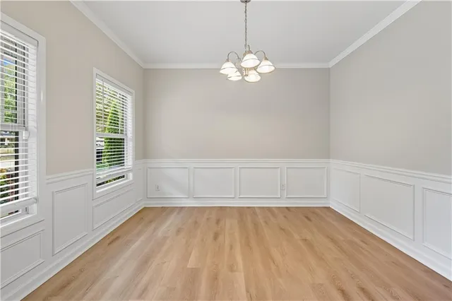 a view of an empty room with a birdcage and a window