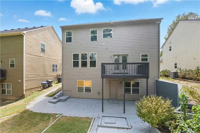 a backyard of a house with sofas fire pit and outdoor seating