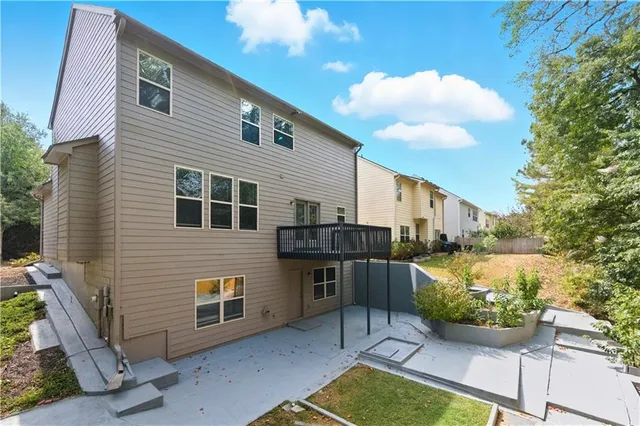 a view of a house with backyard and sitting area