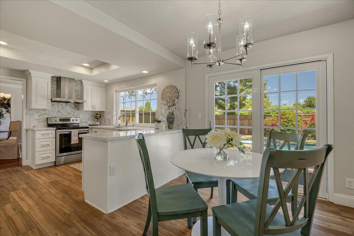 1204 Lubich Drive Mountain View, CA 94040 - Photo 12 of 39 a view of a dining room with furniture window and wooden floor