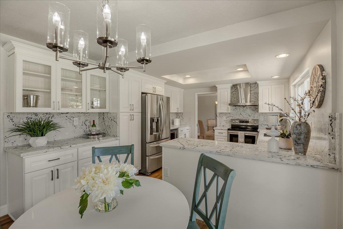 1204 Lubich Drive Mountain View, CA 94040 - Photo 13 of 39 a kitchen with stainless steel appliances kitchen island granite countertop a refrigerator a oven a sink a dining table and chairs with wooden floor