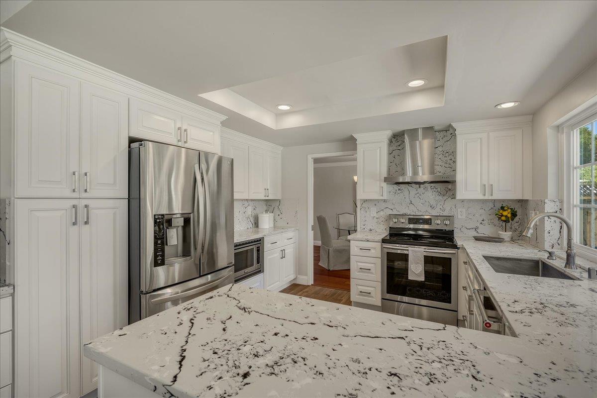 1204 Lubich Drive Mountain View, CA 94040 - Photo 14 of 39 a kitchen with stainless steel appliances granite countertop a sink stove and refrigerator
