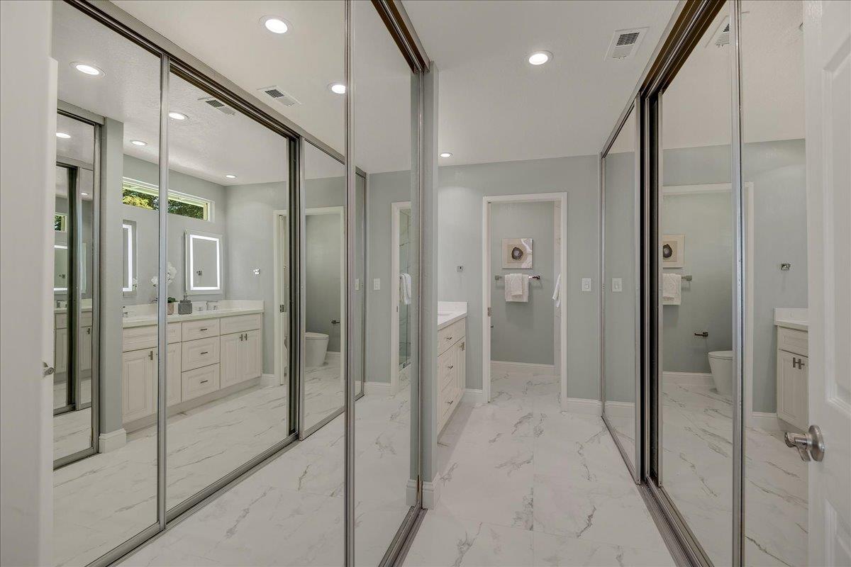 1204 Lubich Drive Mountain View, CA 94040 - Photo 20 of 39 a bathroom with a glass shower door a sink and a mirror