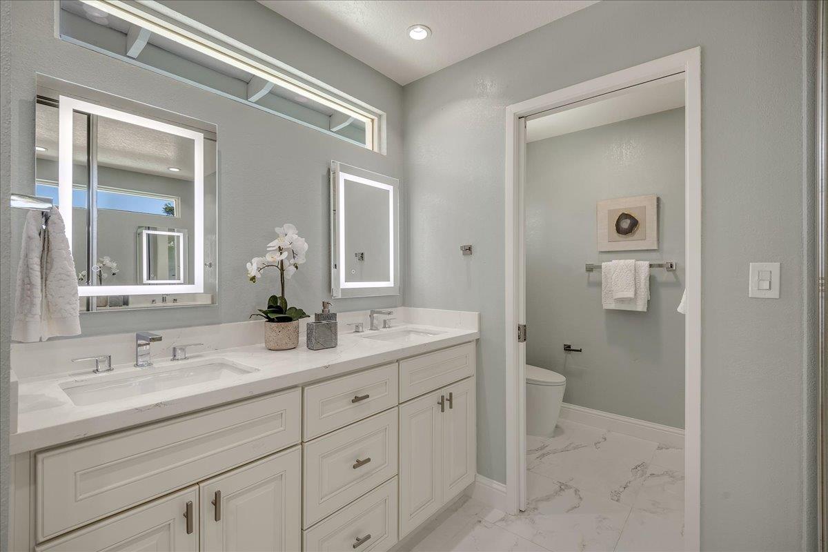 1204 Lubich Drive Mountain View, CA 94040 - Photo 21 of 39 a bathroom with a granite countertop sink mirror and toilet