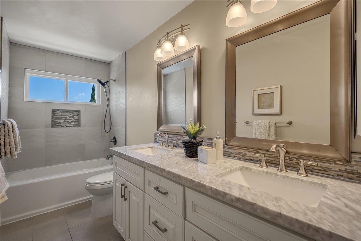 1204 Lubich Drive Mountain View, CA 94040 - Photo 27 of 39 a bathroom with a granite countertop sink double mirror bathtub and toilet