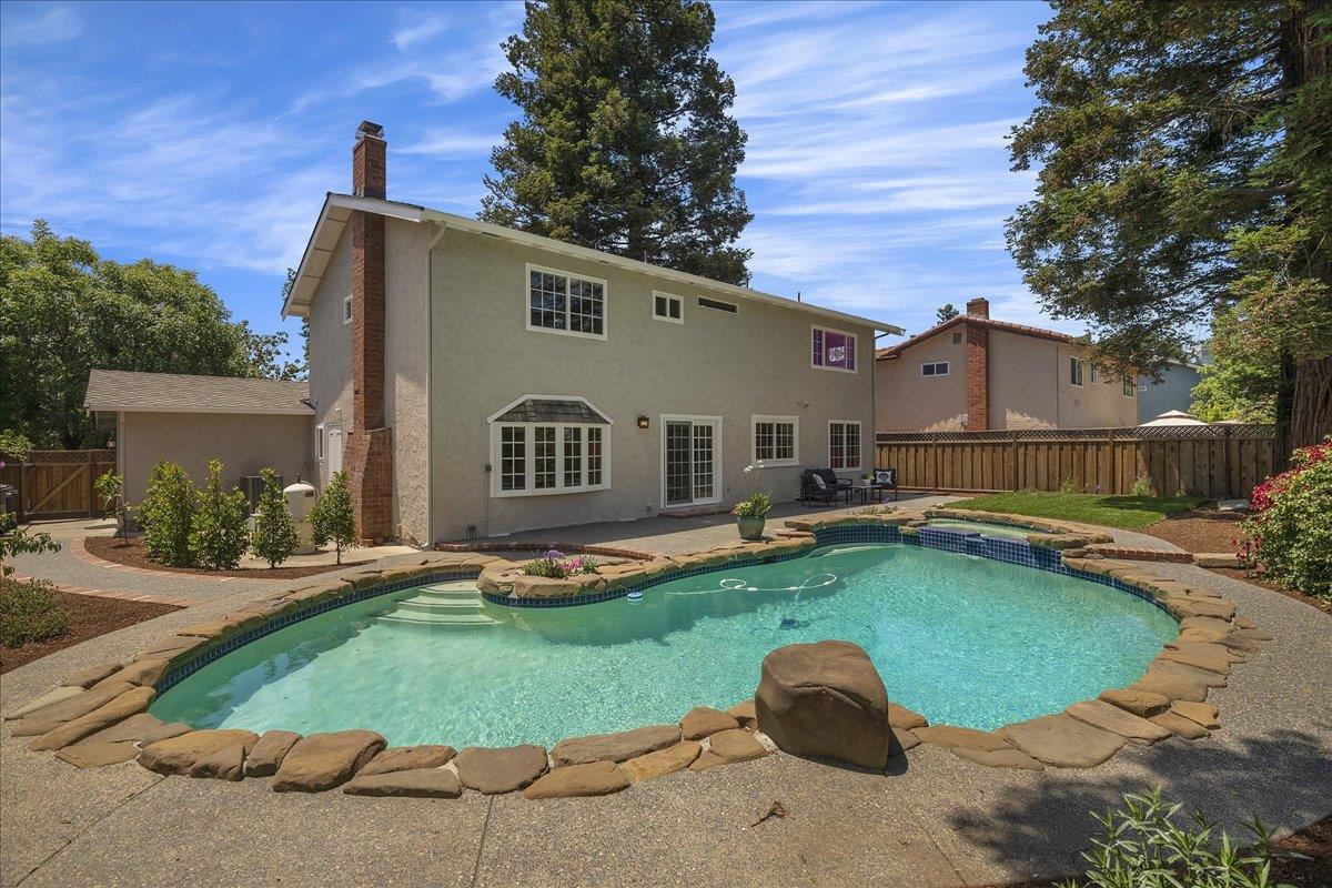1204 Lubich Drive Mountain View, CA 94040 - Photo 36 of 39 a view of a white house with a yard plants and large tree