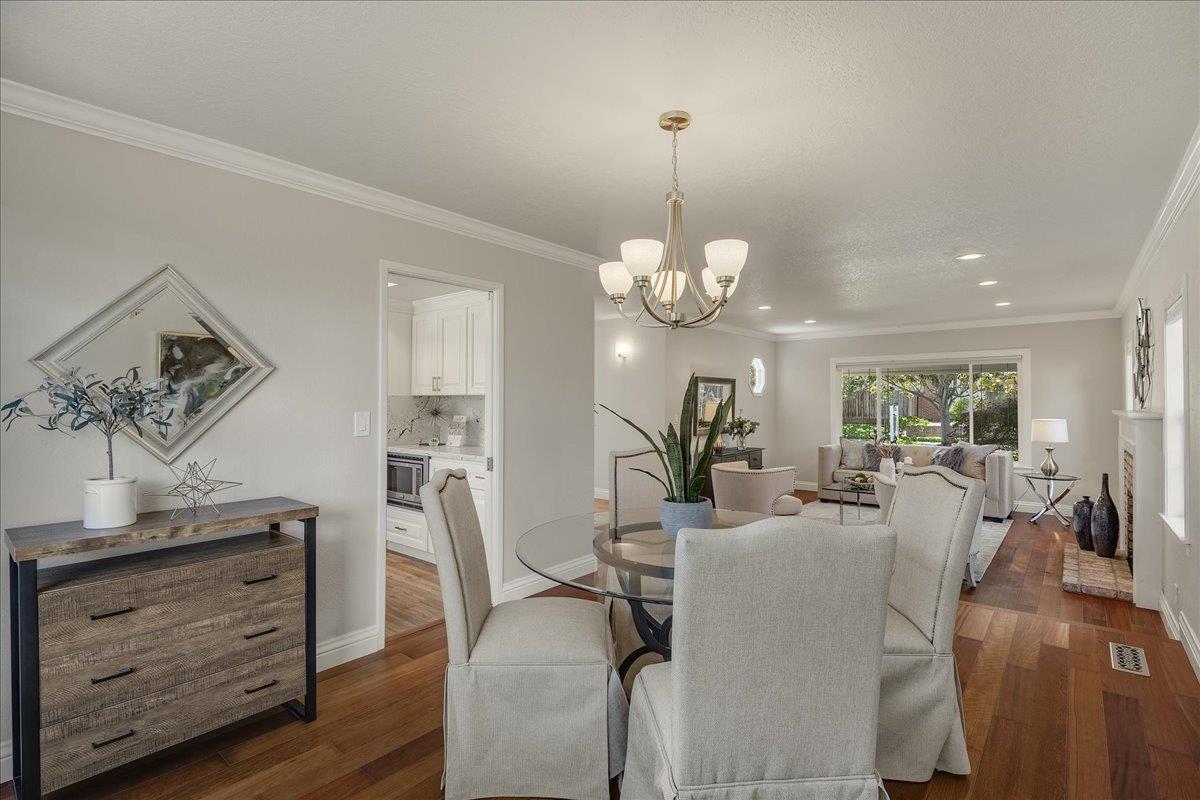 1204 Lubich Drive Mountain View, CA 94040 - Photo 9 of 39 a view of a dining room and a livingroom with furniture wooden floor a chandelier