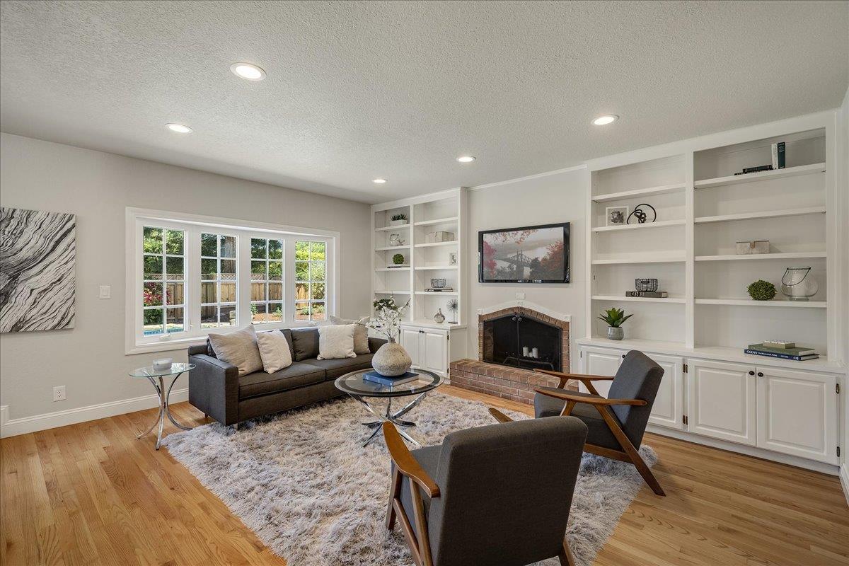 1204 Lubich Drive Mountain View, CA 94040 - Photo 10 of 39 a living room with furniture window and a fireplace