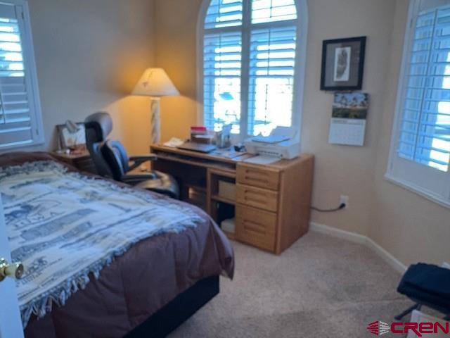 440 Southeast Old Goat Trail Cedaredge, CO 81413 - Photo 11 of 13 a bed room with a bed and a lamp