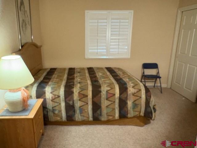440 Southeast Old Goat Trail Cedaredge, CO 81413 - Photo 10 of 13 a bedroom with a bed and a chair