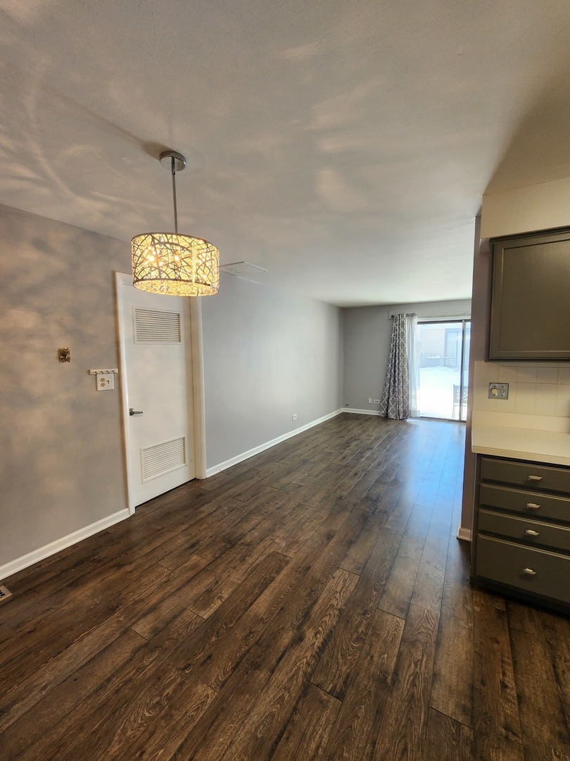 123 Brewster Court, Unit B Bloomingdale, IL 60108 - Photo 13 of 23 a view of a livingroom with wooden floor and a ceiling fan