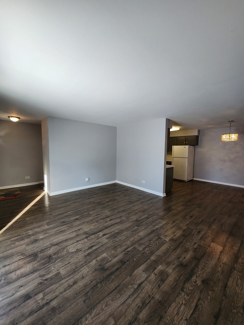 123 Brewster Court, Unit B Bloomingdale, IL 60108 - Photo 16 of 23 a view of empty room with wooden floor