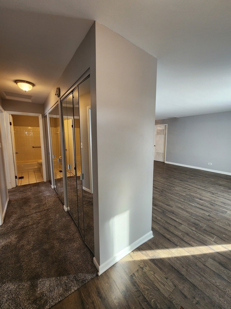 123 Brewster Court, Unit B Bloomingdale, IL 60108 - Photo 17 of 23 a view of a hallway with wooden floor