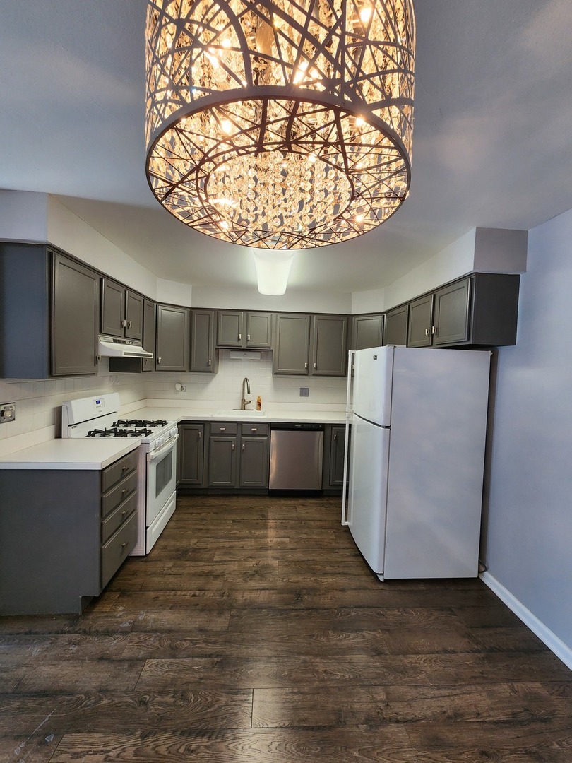 123 Brewster Court, Unit B Bloomingdale, IL 60108 - Photo 5 of 23 a view of a kitchen with a sink and dishwasher a refrigerator with wooden floor