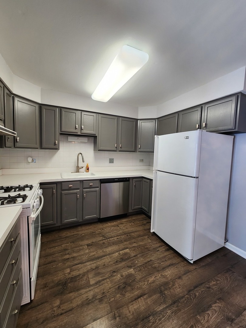 123 Brewster Court, Unit B Bloomingdale, IL 60108 - Photo 7 of 23 a kitchen with stainless steel appliances a refrigerator sink and cabinets