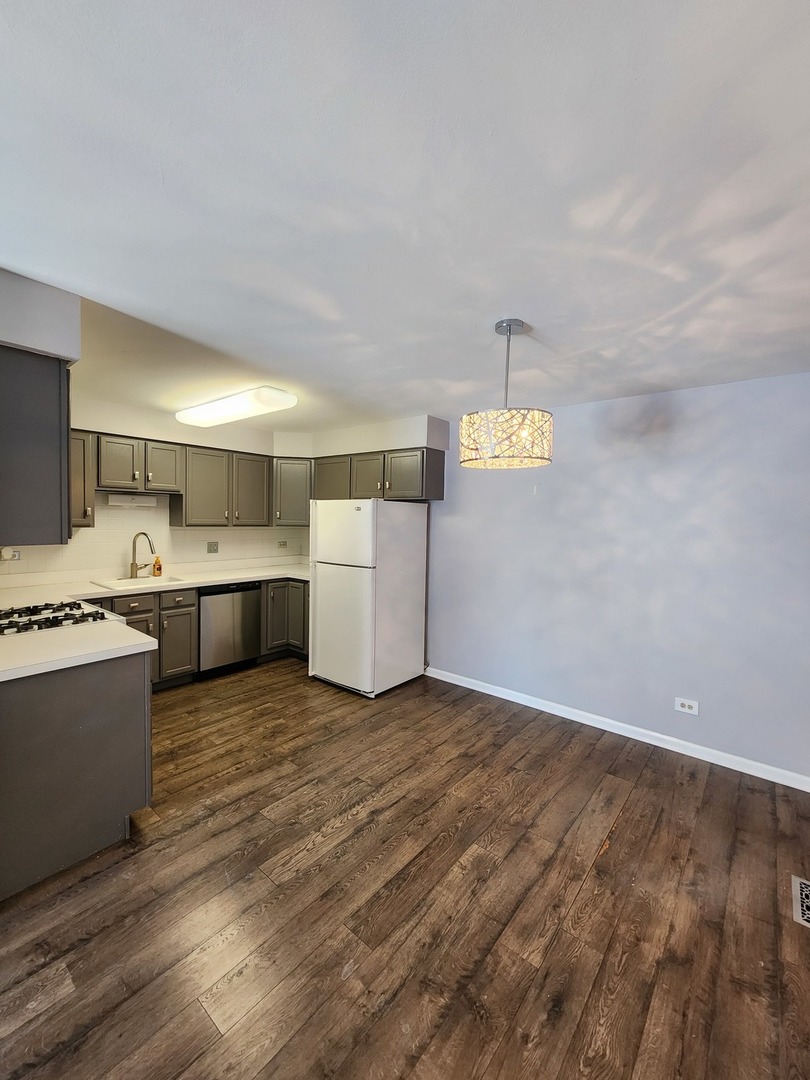 123 Brewster Court, Unit B Bloomingdale, IL 60108 - Photo 8 of 23 a living room with hard wood floors and kitchen view