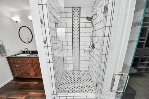 a bathroom with a sink a toilet and shower