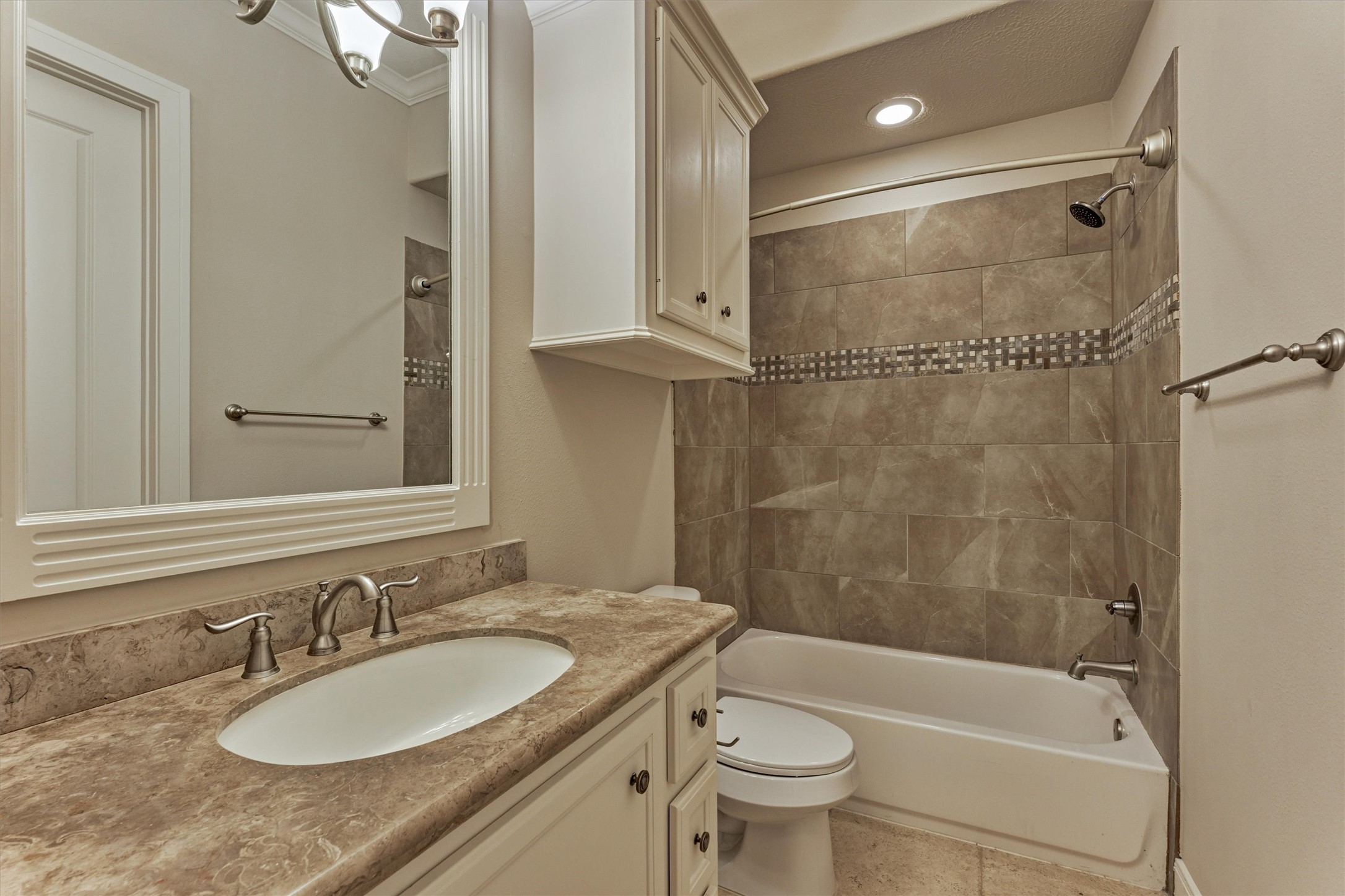 25 Post Shadow Estate Drive Spring, TX 77389 - Photo 37 of 49 Spa-inspired bathroom with tiled tub surround, decorative mosaic band, and generous vanity storage.