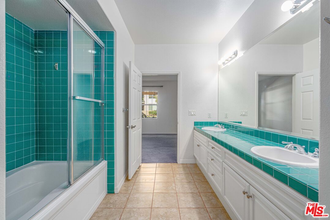 13080 Pacific Promenade, Unit 109 Playa Vista, CA 90094 - Photo 14 of 60 a bathroom with a granite countertop tub sink and mirror