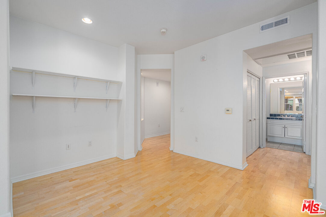 13080 Pacific Promenade, Unit 109 Playa Vista, CA 90094 - Photo 17 of 60 a view of a big room with closet and wooden floor