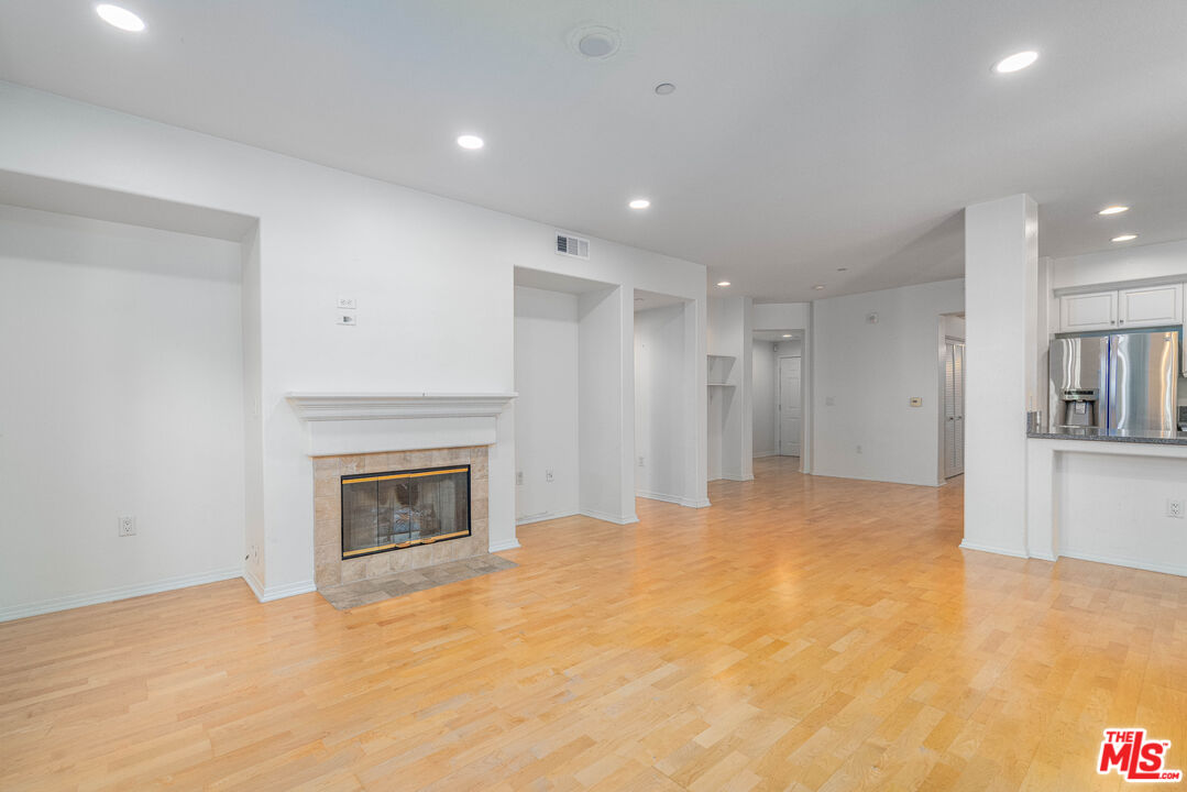 13080 Pacific Promenade, Unit 109 Playa Vista, CA 90094 - Photo 3 of 60 a view of empty room with a fireplace and cabinet