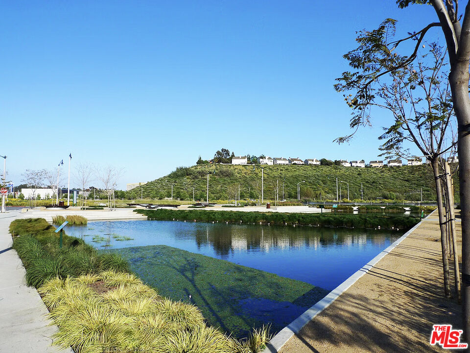 13080 Pacific Promenade, Unit 109 Playa Vista, CA 90094 - Photo 56 of 60 a view of a lake with houses in the back
