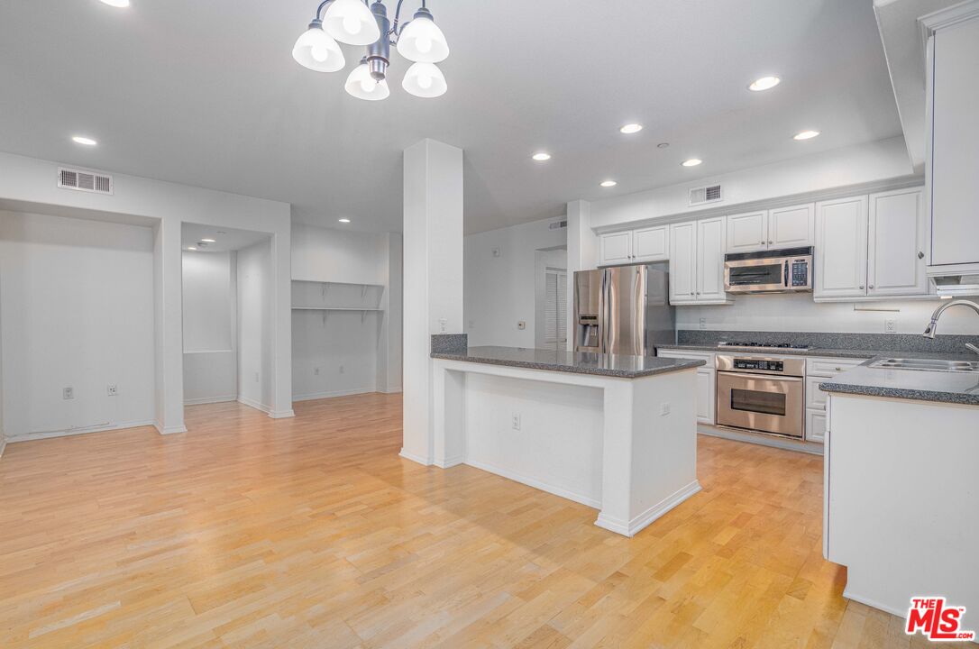 13080 Pacific Promenade, Unit 109 Playa Vista, CA 90094 - Photo 6 of 60 a kitchen with stainless steel appliances a refrigerator sink and stove
