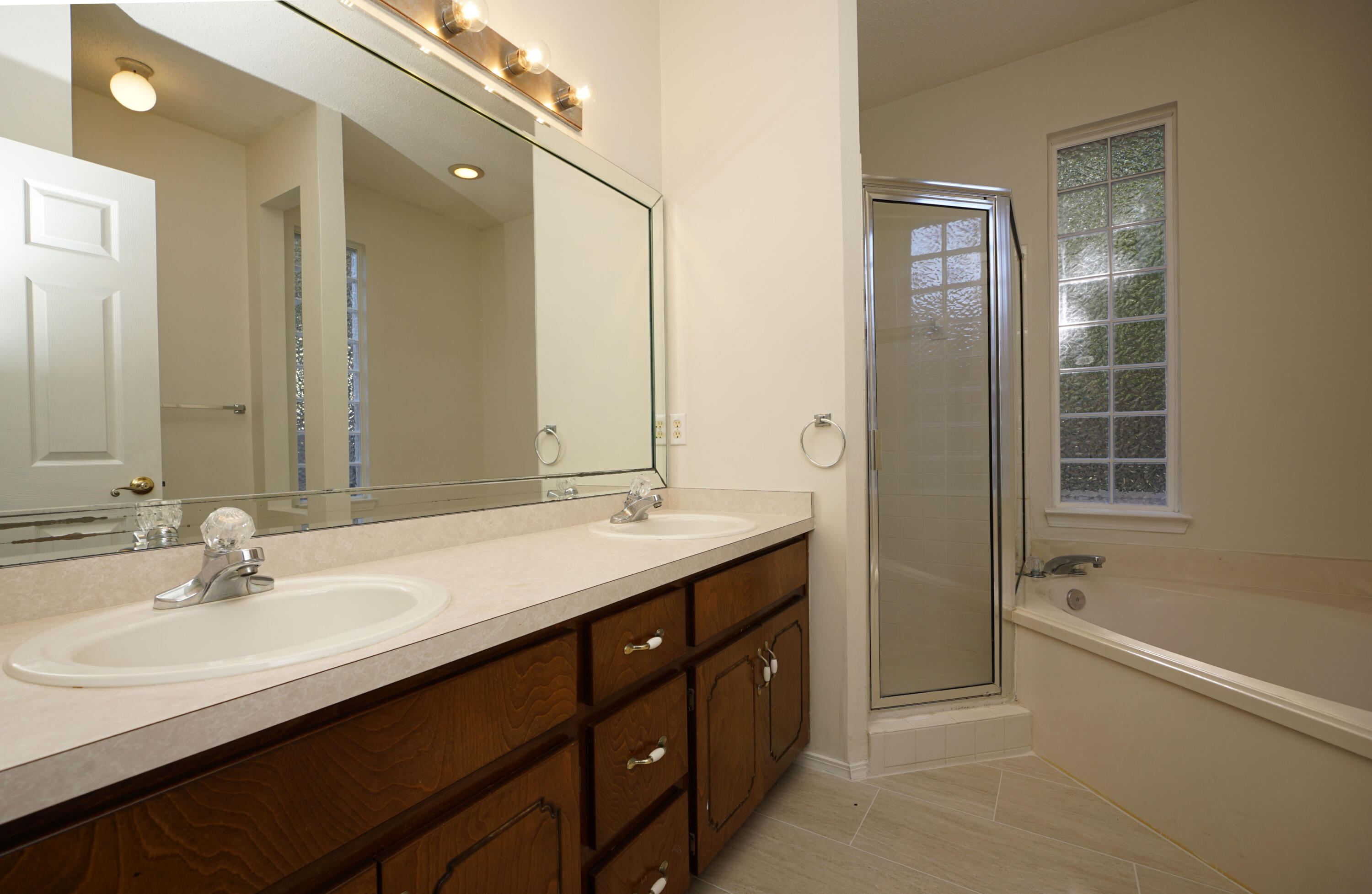 4505 Parkwood Square Niceville, FL 32578 - Photo 16 of 30 a bathroom with a tub sink double vanity granite and shower