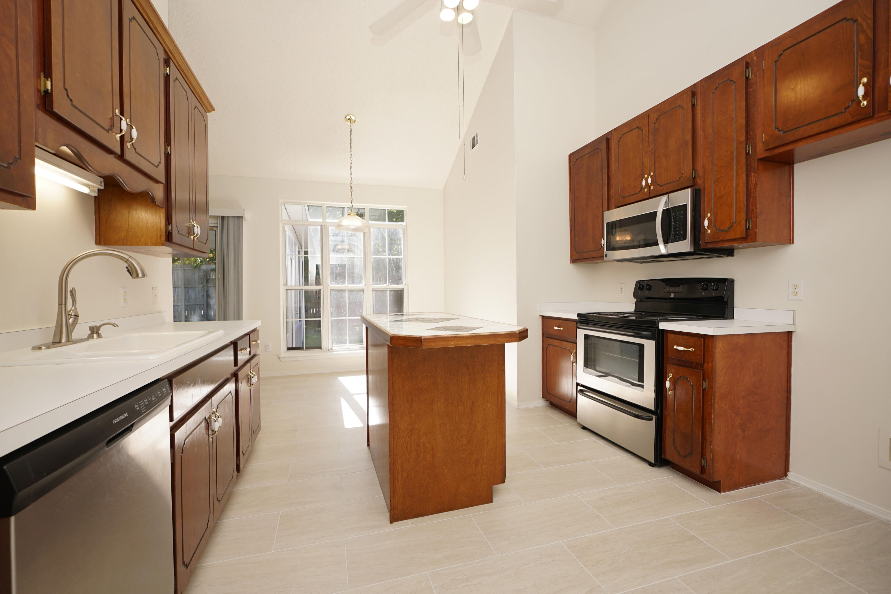 4505 Parkwood Square Niceville, FL 32578 - Photo 2 of 30 a kitchen with stainless steel appliances granite countertop a stove a sink and a microwave