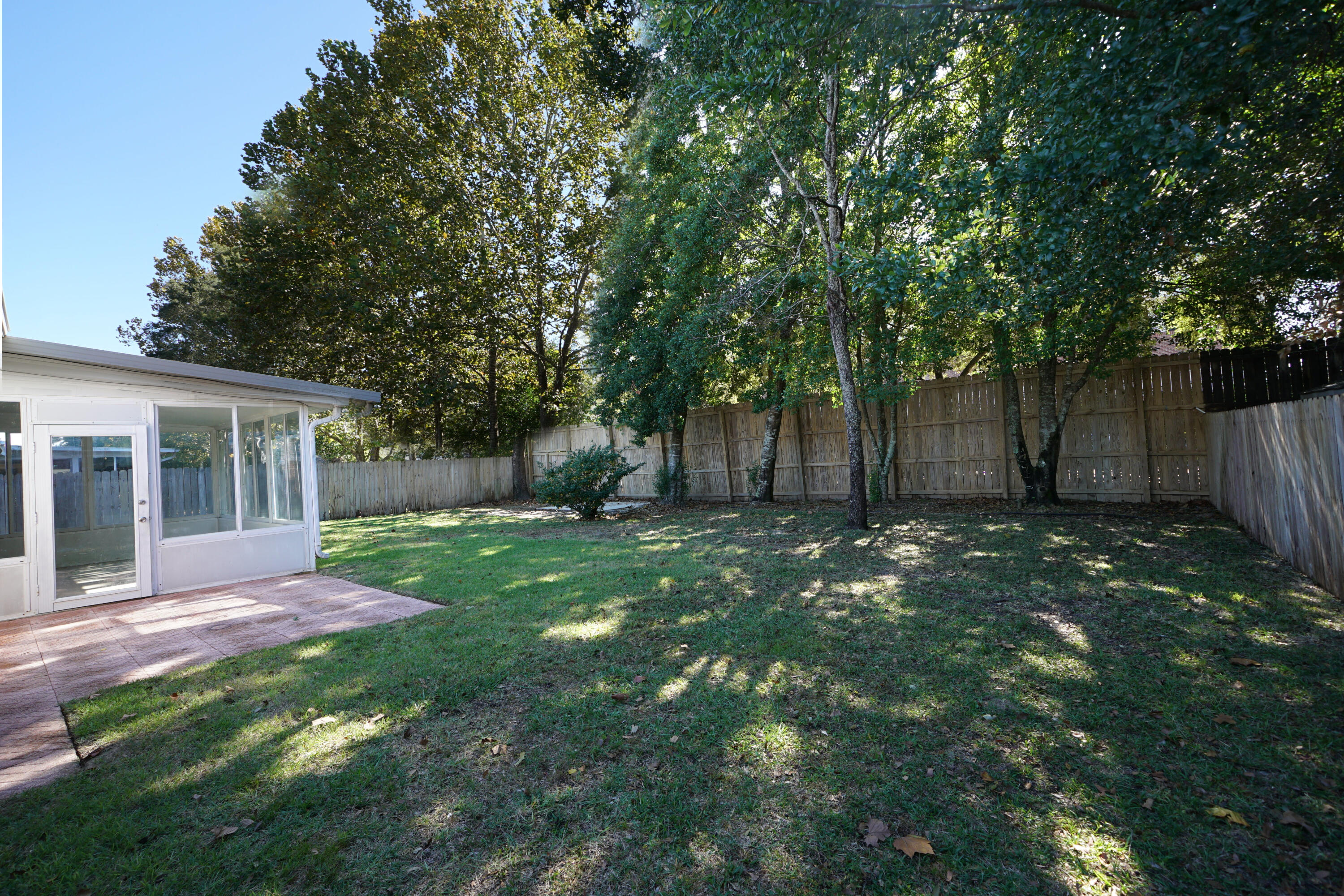 4505 Parkwood Square Niceville, FL 32578 - Photo 24 of 30 a view of a backyard with table and chairs and a large tree
