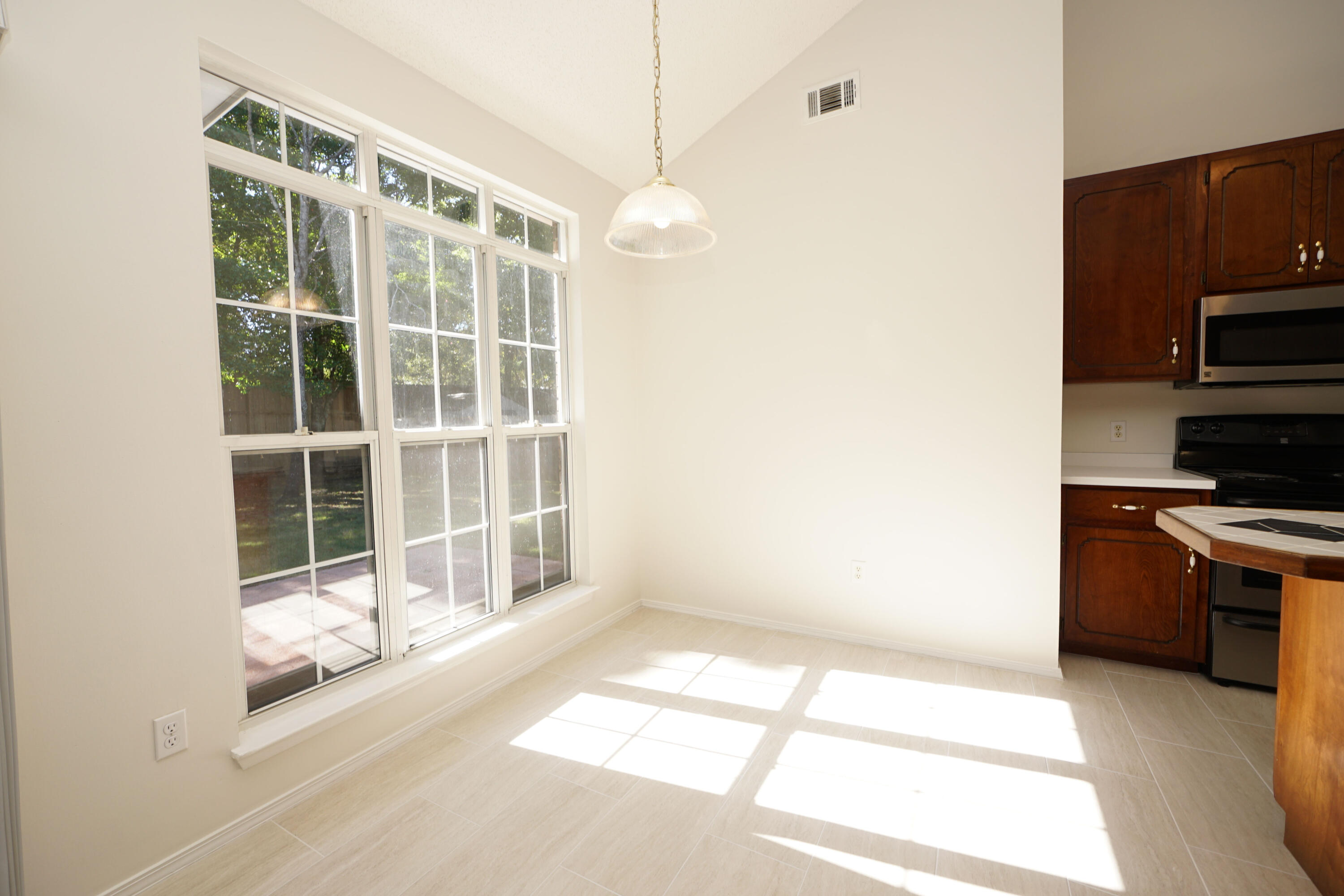 4505 Parkwood Square Niceville, FL 32578 - Photo 6 of 30 a view of a kitchen with wooden floor and windows