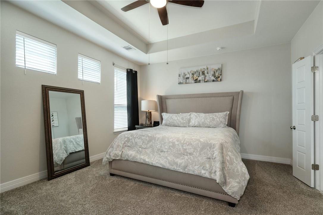 229 Bonnet Boulevard Georgetown, TX 78628 - Photo 8 of 20 Carpeted bedroom featuring a raised ceiling and a ceiling fan