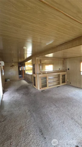 a view of a hallway with wooden shelves