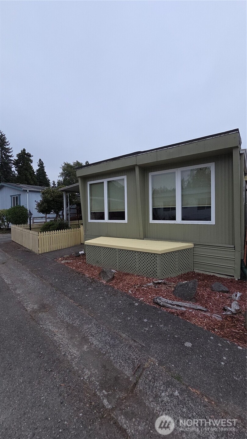 8314 38th Street East, Unit 4 Edgewood, WA 98371 - Photo 2 of 21 a front view of a house with a yard