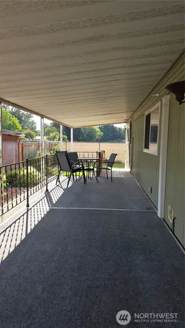 a view of a patio with table and chairs