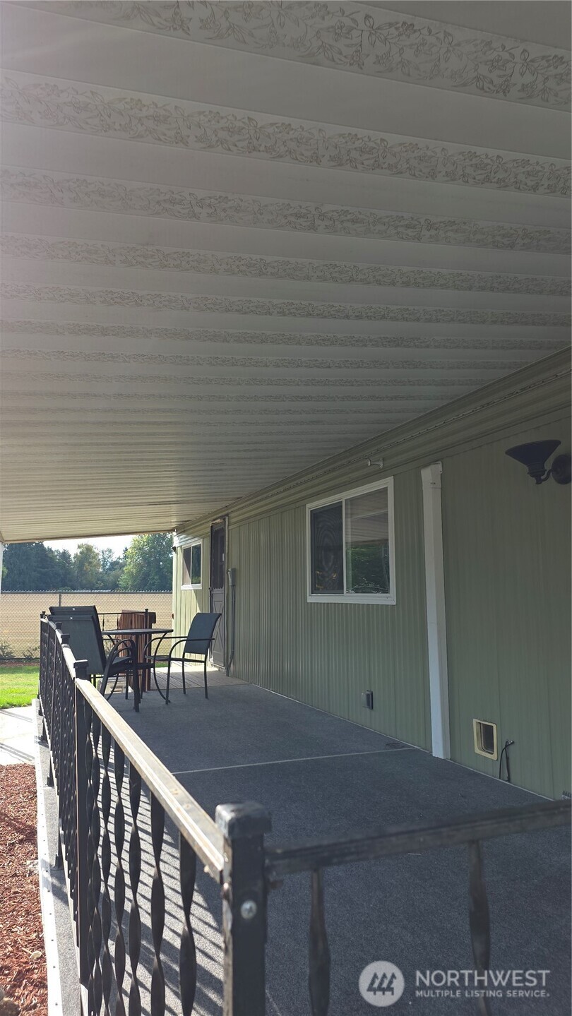 8314 38th Street East, Unit 4 Edgewood, WA 98371 - Photo 7 of 21 a view of a porch and garden