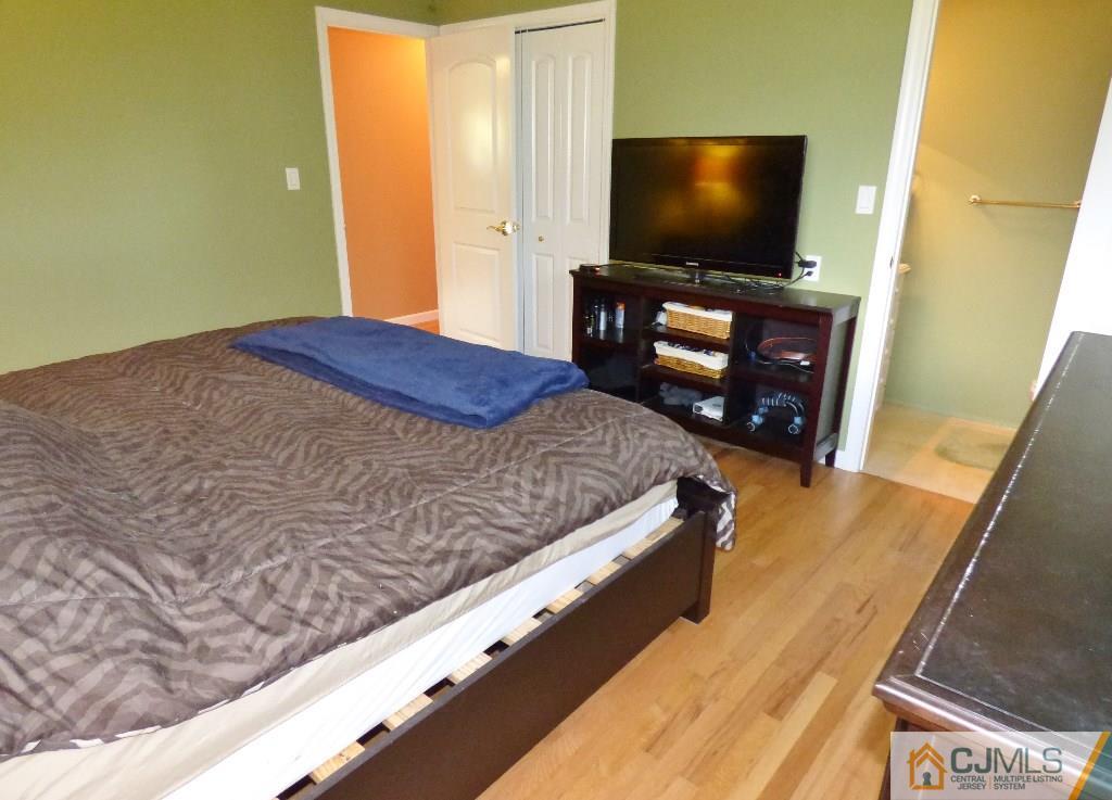20 Clemson Road Old Bridge, NJ 08859 - Photo 11 of 25 a bedroom with a bed and flat screen tv