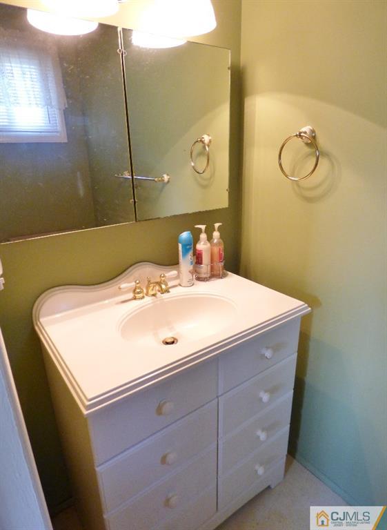 20 Clemson Road Old Bridge, NJ 08859 - Photo 13 of 25 a bathroom with a sink and mirror