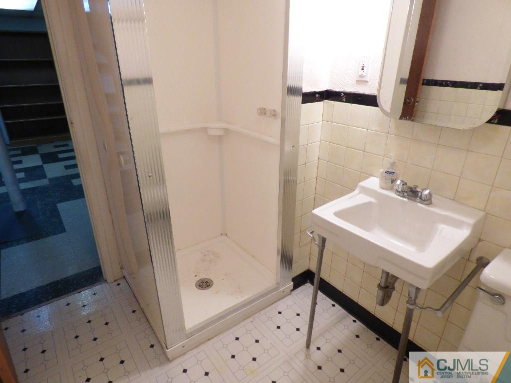 20 Clemson Road Old Bridge, NJ 08859 - Photo 22 of 25 a bathroom with a sink a toilet and shower