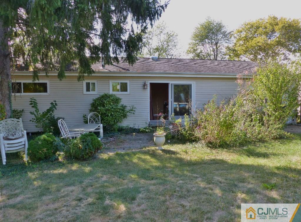 20 Clemson Road Old Bridge, NJ 08859 - Photo 24 of 25 front view of a house with potted plants and a large tree