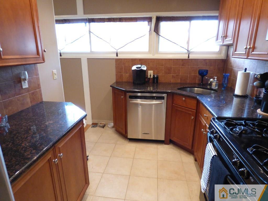 20 Clemson Road Old Bridge, NJ 08859 - Photo 8 of 25 a kitchen with stainless steel appliances granite countertop a sink stove and a window
