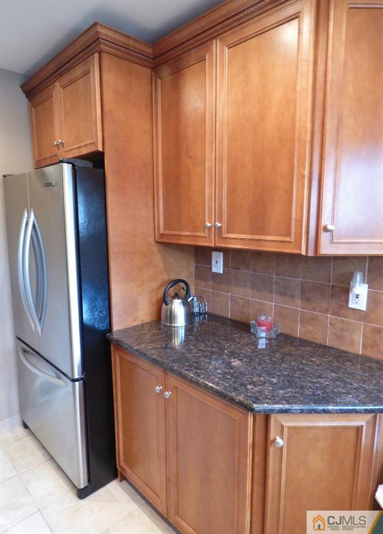 20 Clemson Road Old Bridge, NJ 08859 - Photo 9 of 25 a kitchen with stainless steel appliances granite countertop a refrigerator a sink a stove and cabinets
