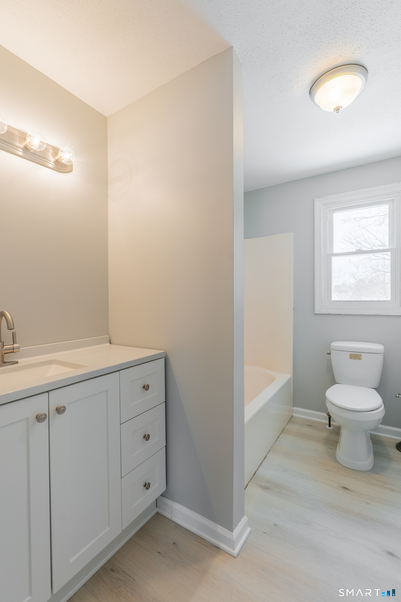 28 Orient Street Meriden, CT 06450 - Photo 13 of 18 a bathroom with a toilet sink and mirror