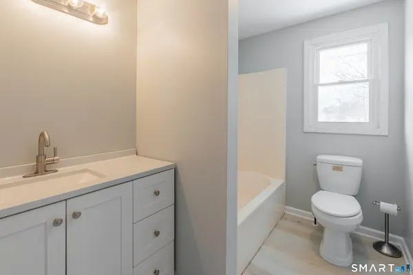 a bathroom with a toilet sink and bathtub