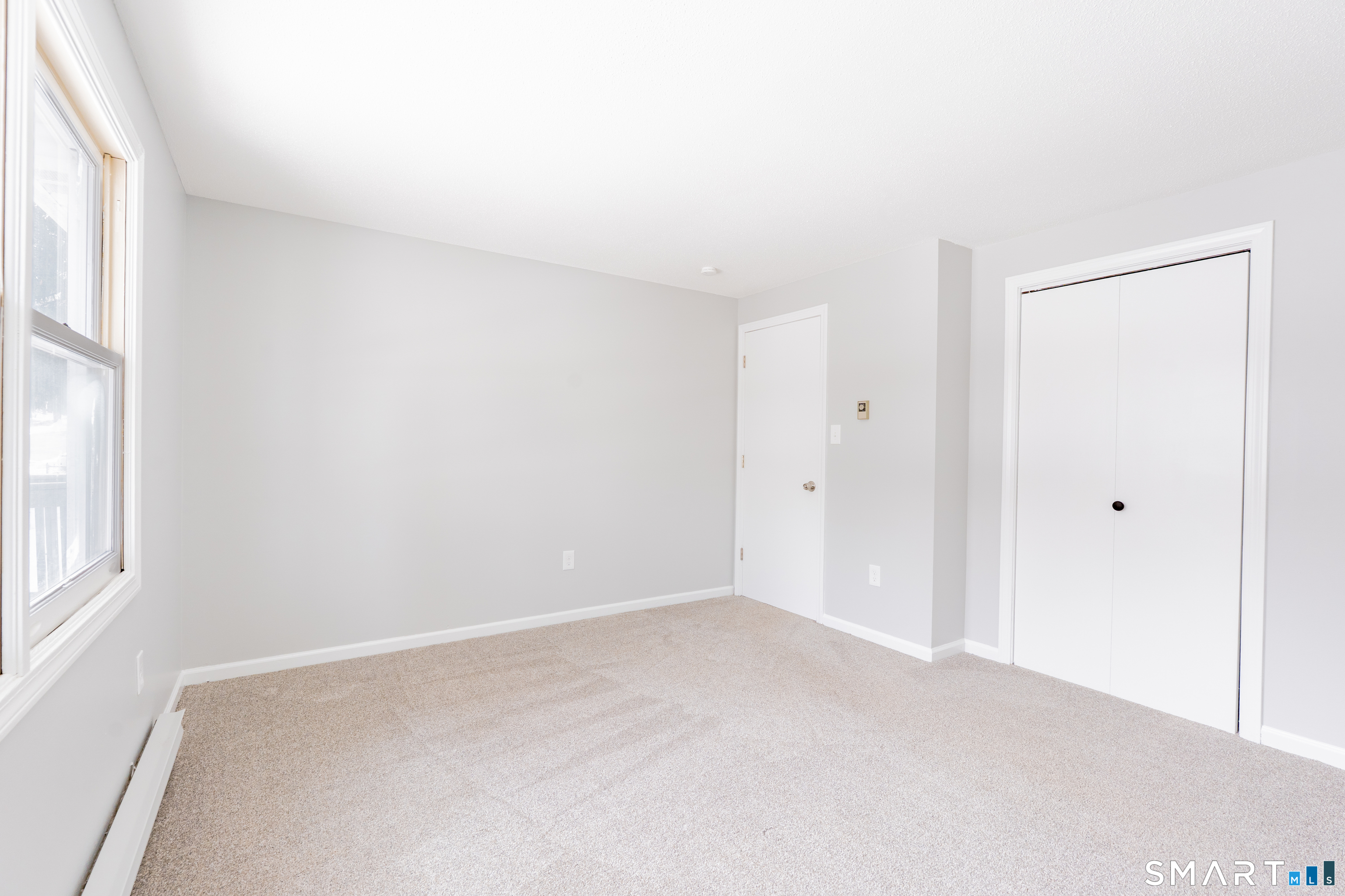 28 Orient Street Meriden, CT 06450 - Photo 16 of 18 an empty room with windows and closet