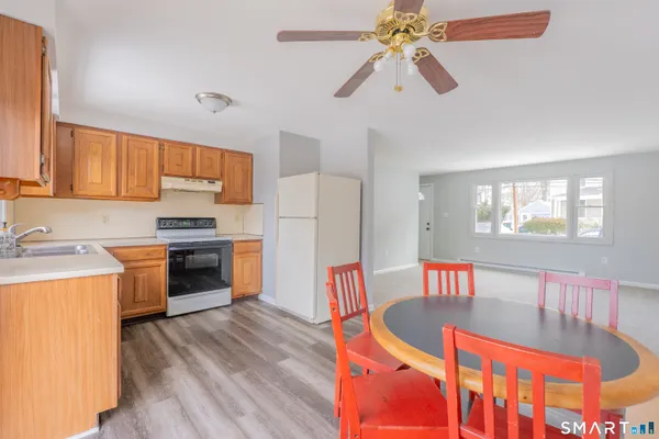 a kitchen with stainless steel appliances kitchen island granite countertop a stove a sink and a refrigerator